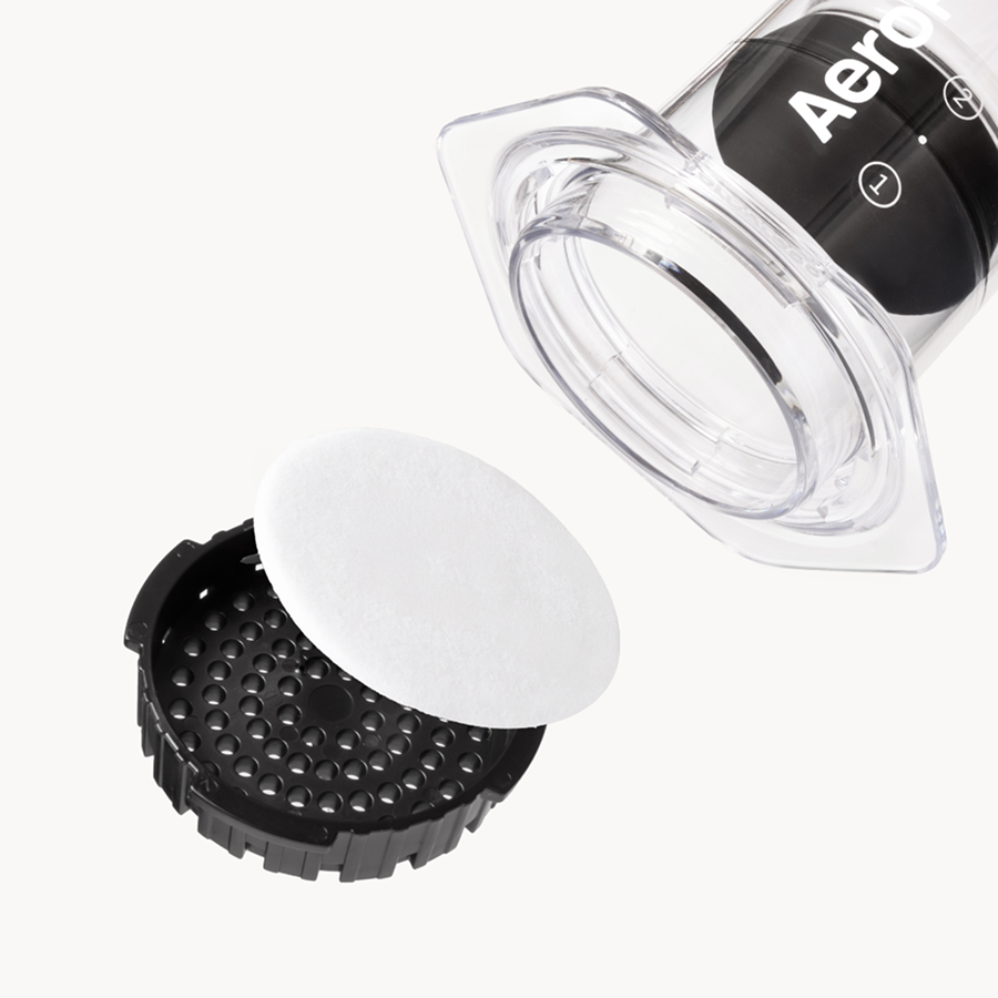 AeroPress coffee maker components on a white background