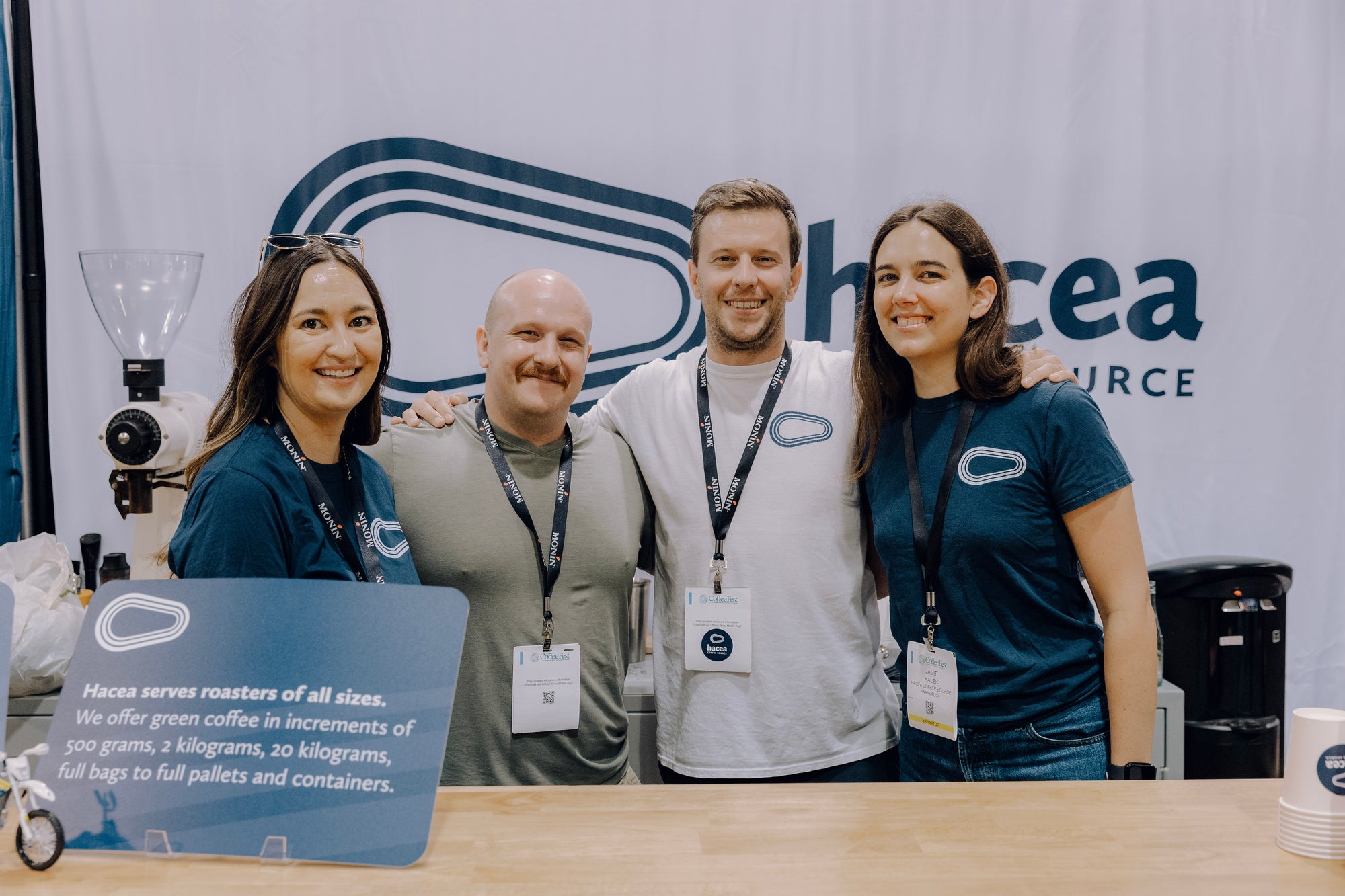 Hacea Team in front of a Hacea banner