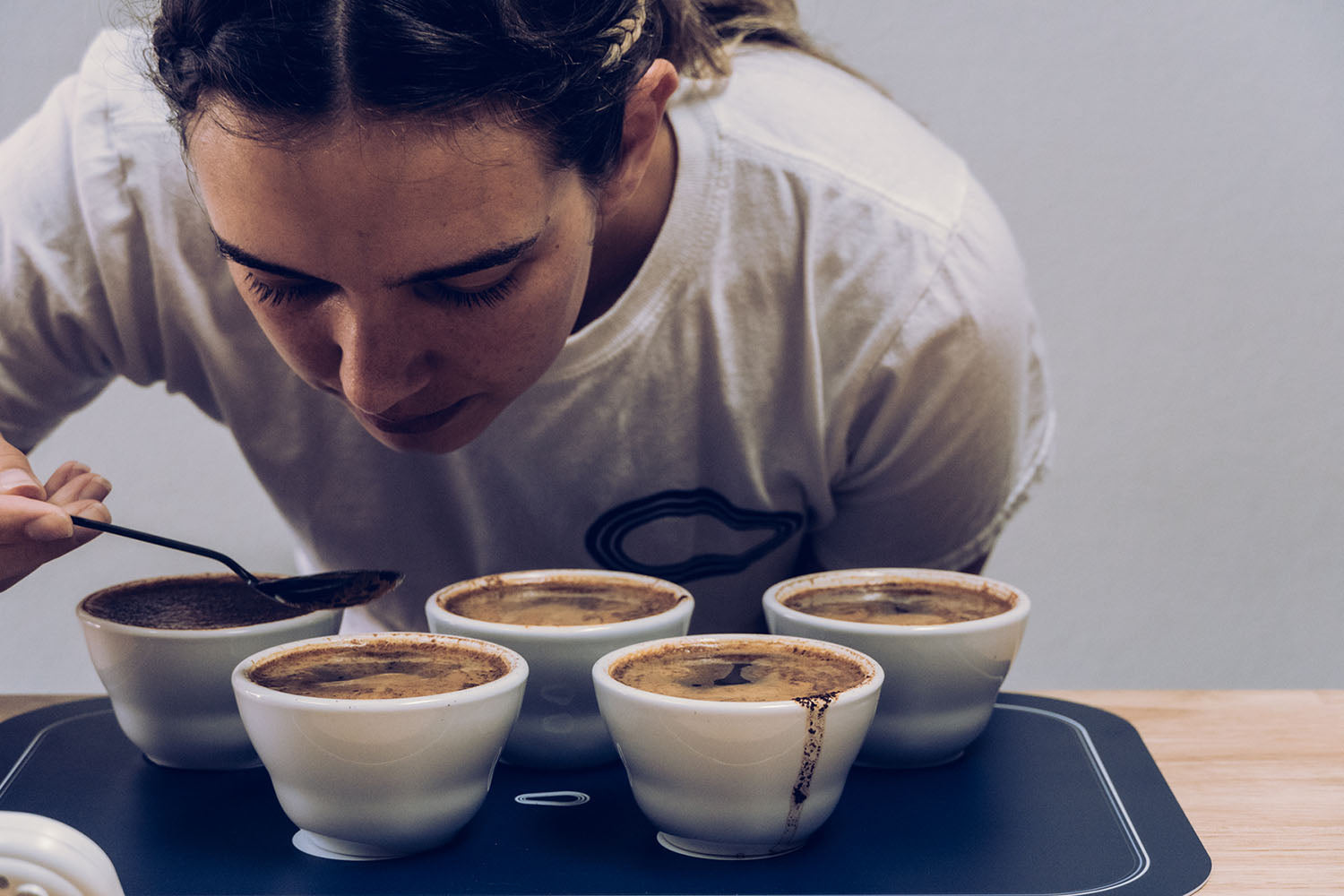 Hacea team member cupping coffee