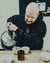 Hacea team member pouring water from a kettle onto coffee grounds in cupping bowls.